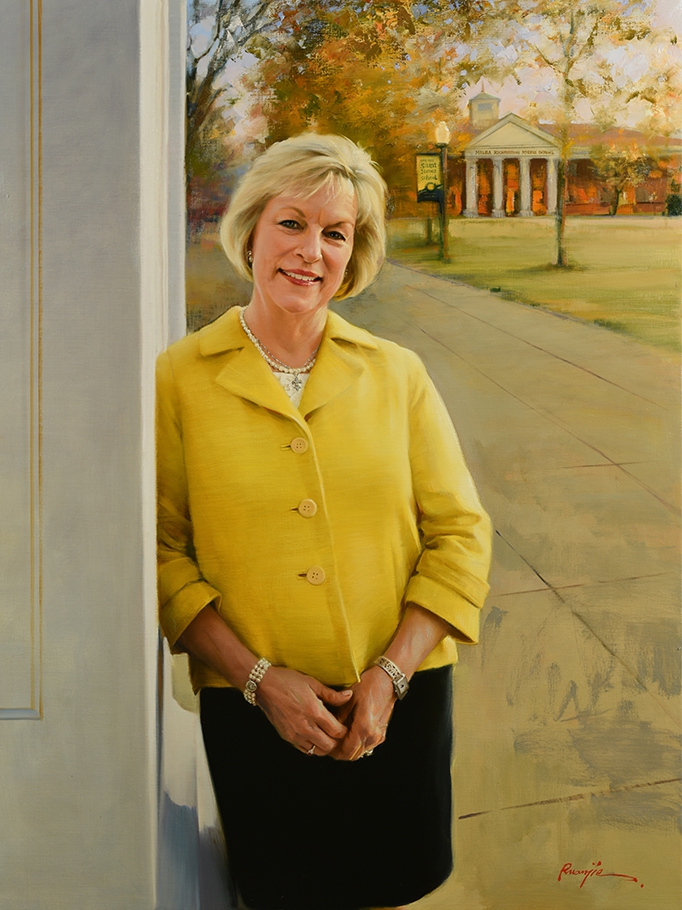 commissioned portrait of woman dressed in yellow and black, leaning on a building with campus in background.