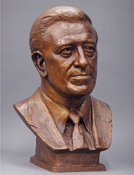 commissioned portrait of bronze-colored bust of a man. 