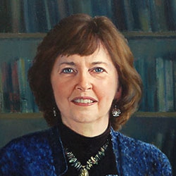 commissioned portrait of woman in blue standing in an academic office space.