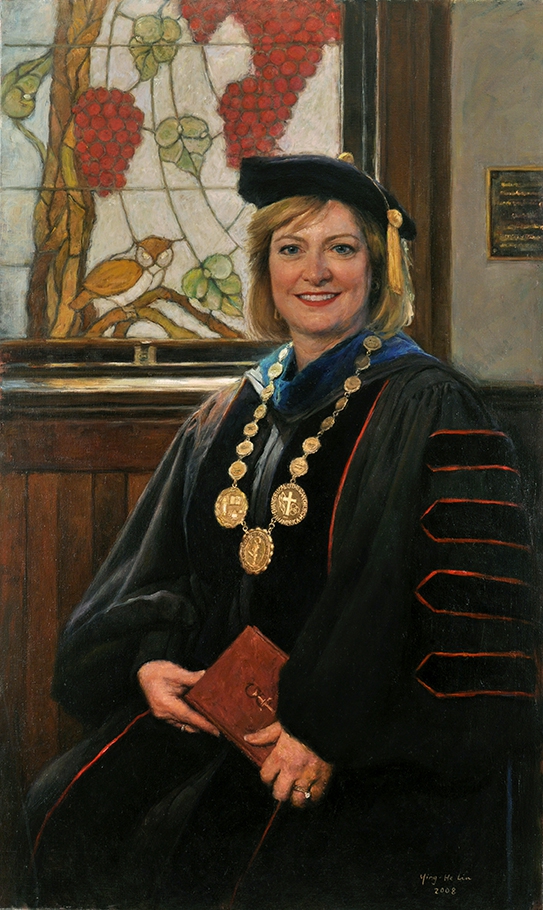 commissioned portrait of woman in academic robes and cap, holding a book.