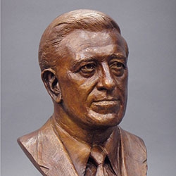 commissioned portrait of bronze-colored bust of a man. 